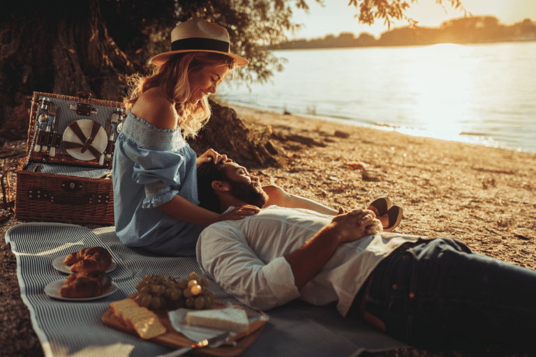 Couple having a picnic near the water