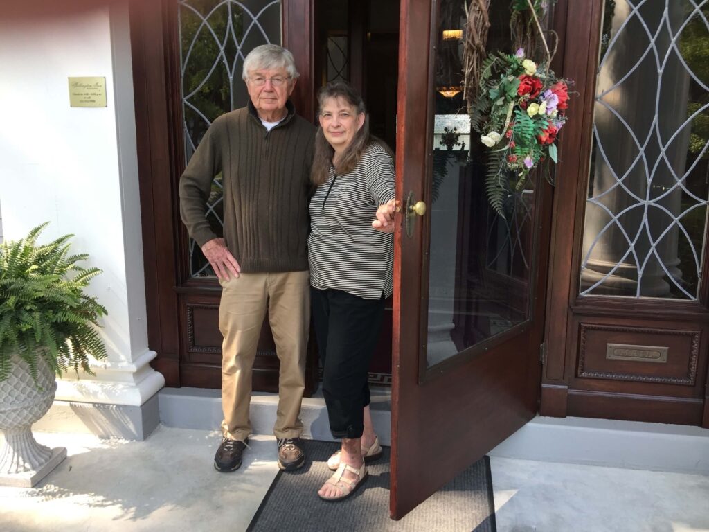 Couple standing infant of their inn -Wellington Inn