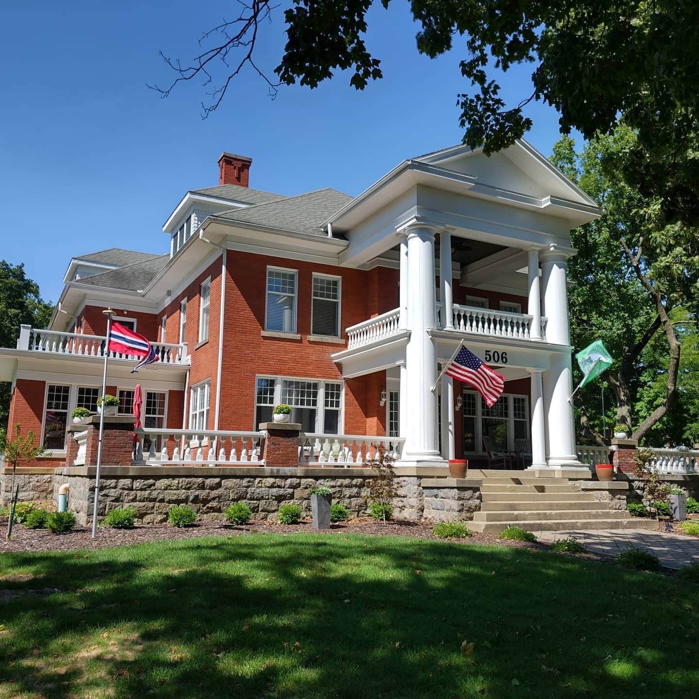 Exterior of Nordic Pineapple B&B. Red brick with grand white columns