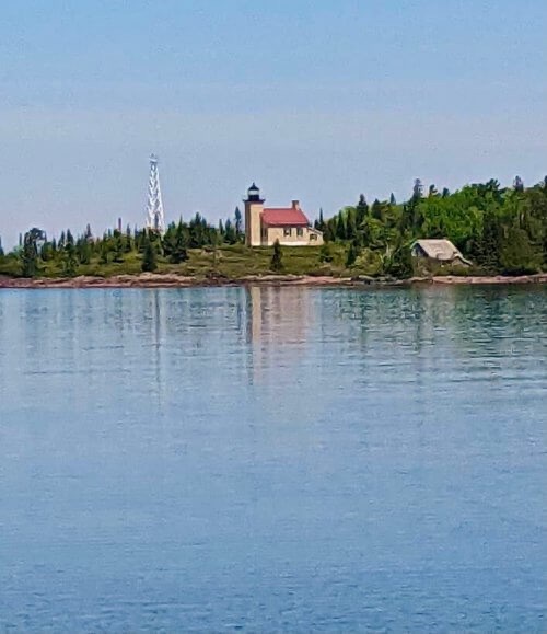 Copper Harbor lighthouse as seen from a park across the harbor