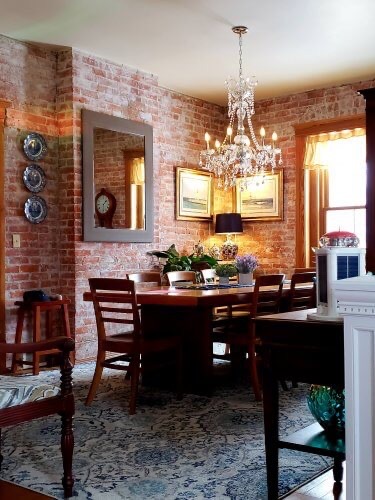 A crystal chandelier hangs above the dining table.