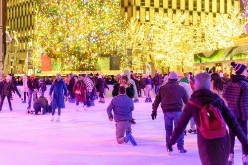 Man proposes to woman on the ice rink at Campus Martius Park in Detroit