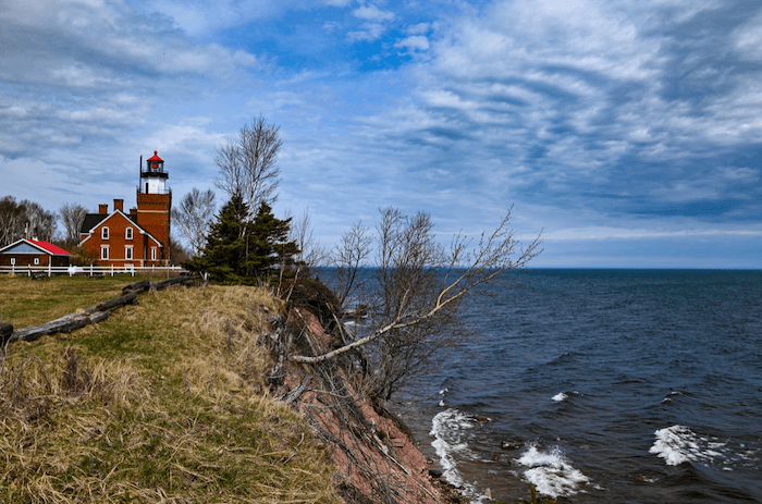 Big Bay Lighthouse. Red brick lighthouse with keepers house sitting on the cliffs of Lake Superior