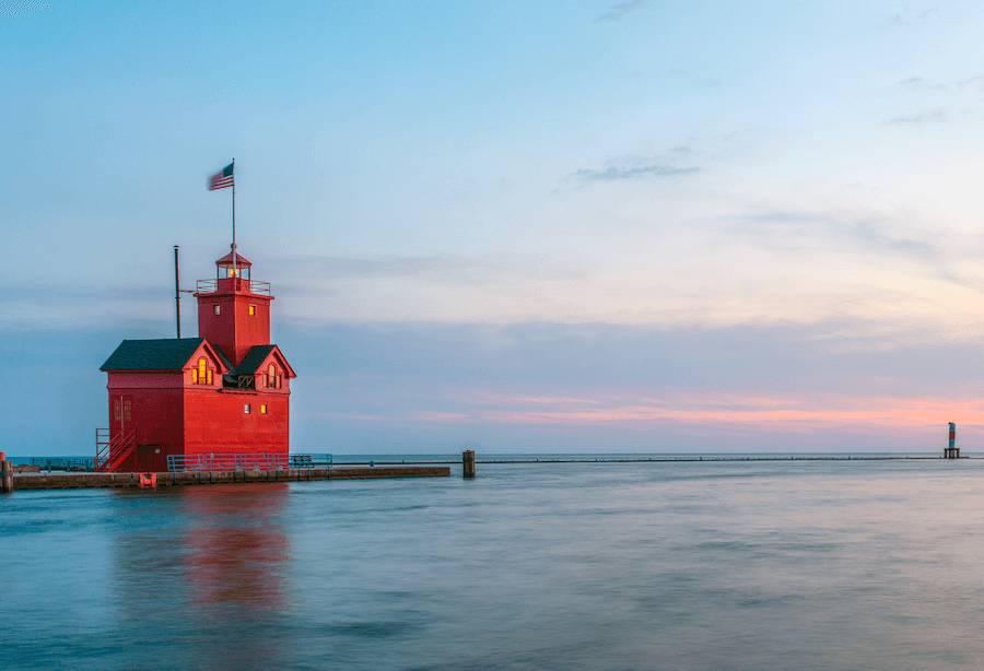 Big Red Lighthouse with a flag and blue skies