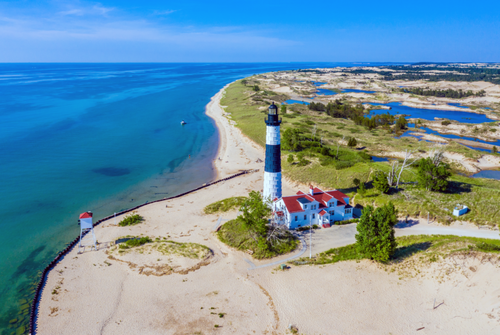 Aerial view of Big Sable Lighthouse surrounded by beautiful beaches and water