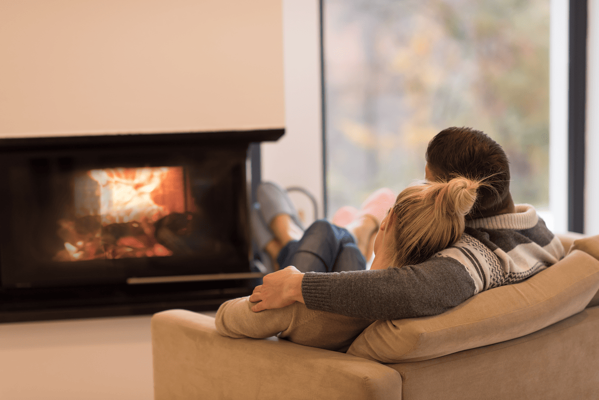 Couple relaxing in front of a fire