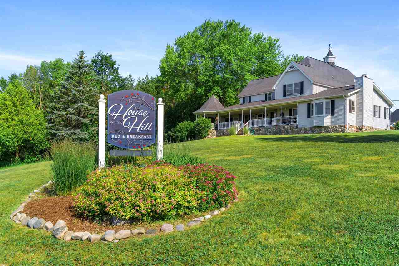 Front view House on The Hill Bed and Breakfast showing Signage and beautiful porch and Gazebo.