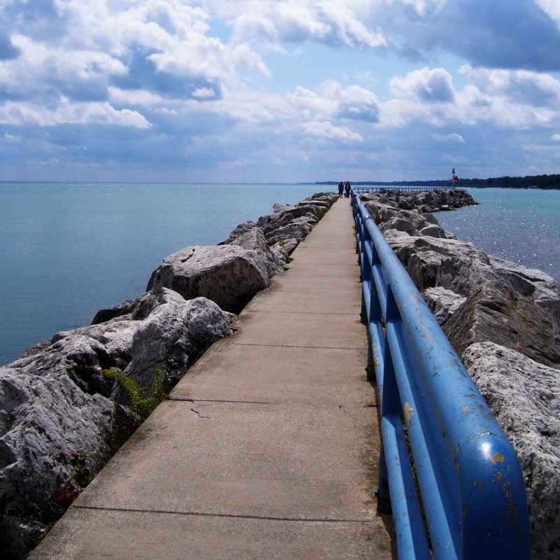 Best Places to Visit in Michigan this Summer 5 Pier in Lexington with Blue rail and rocks