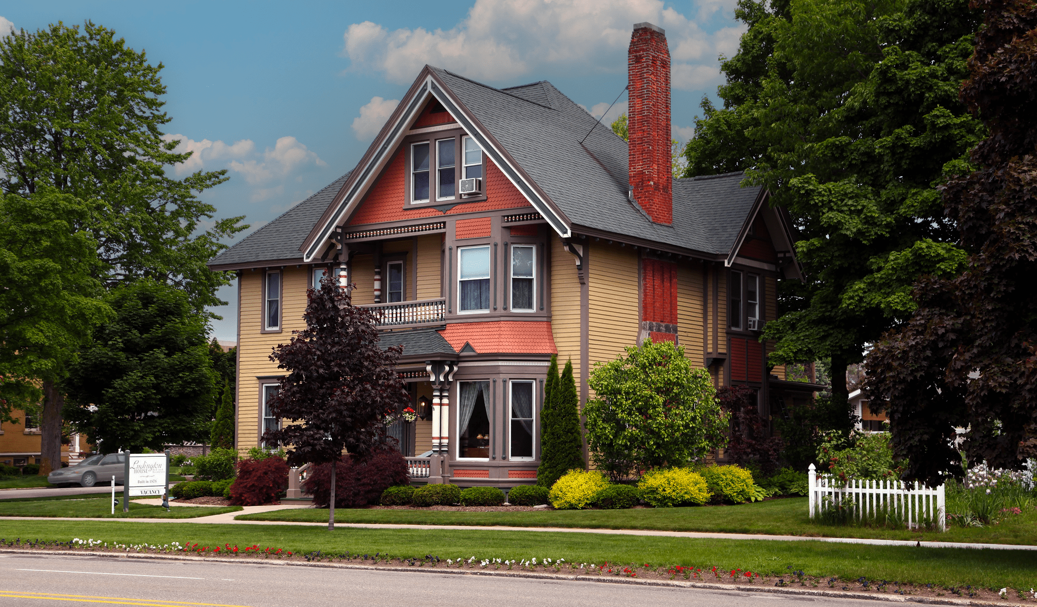 Exterior of the Ludington House Inn, A victorian three story multi color historic home in Ludington, Mi