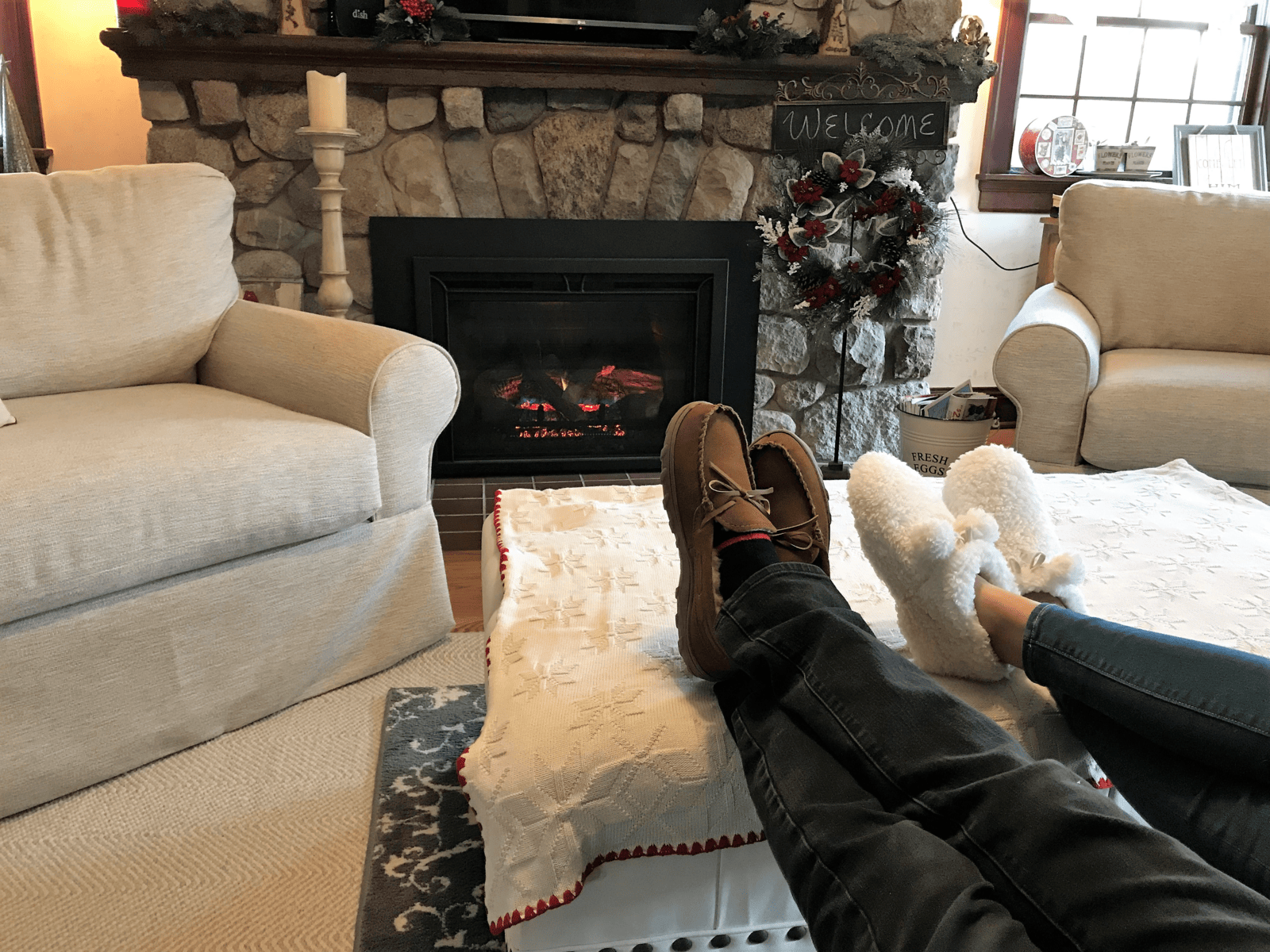 Couple sitting in front of a fire with slippers