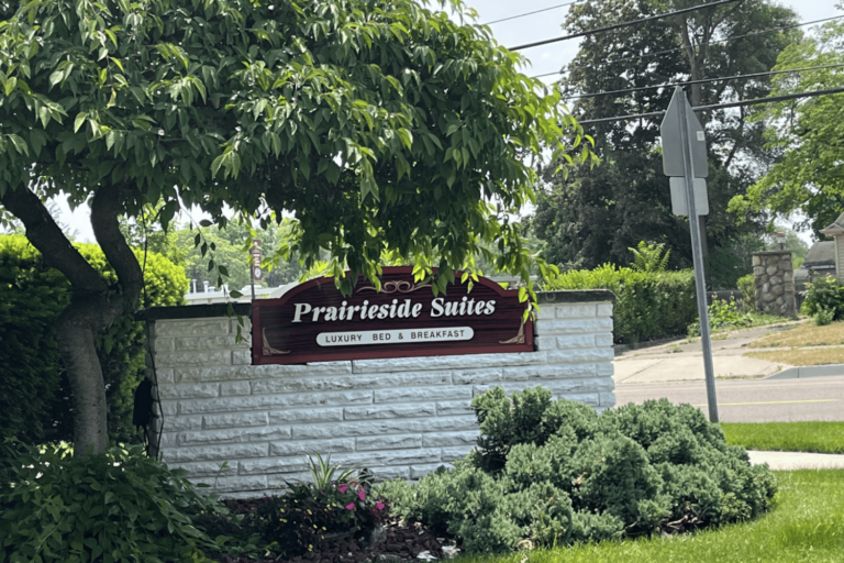 White brick sign at the Prairieside Suites