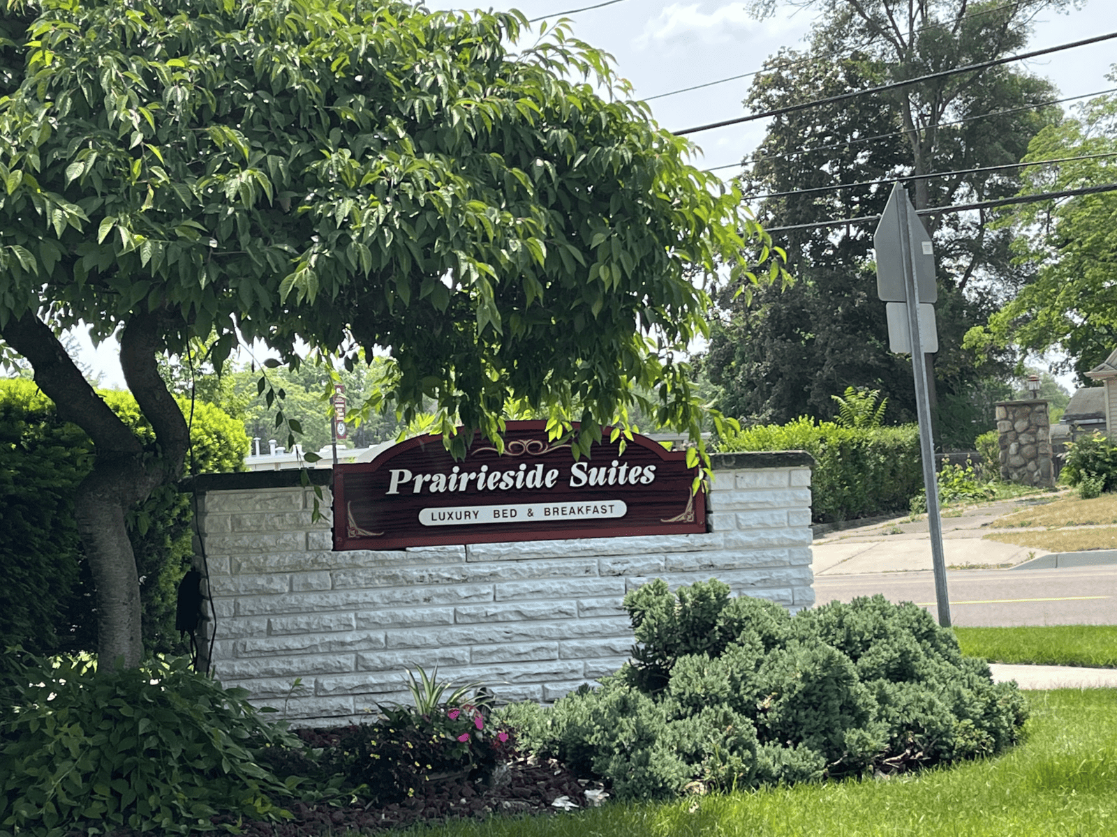 Prairieside Suites B&B Sign on a Brick Wall