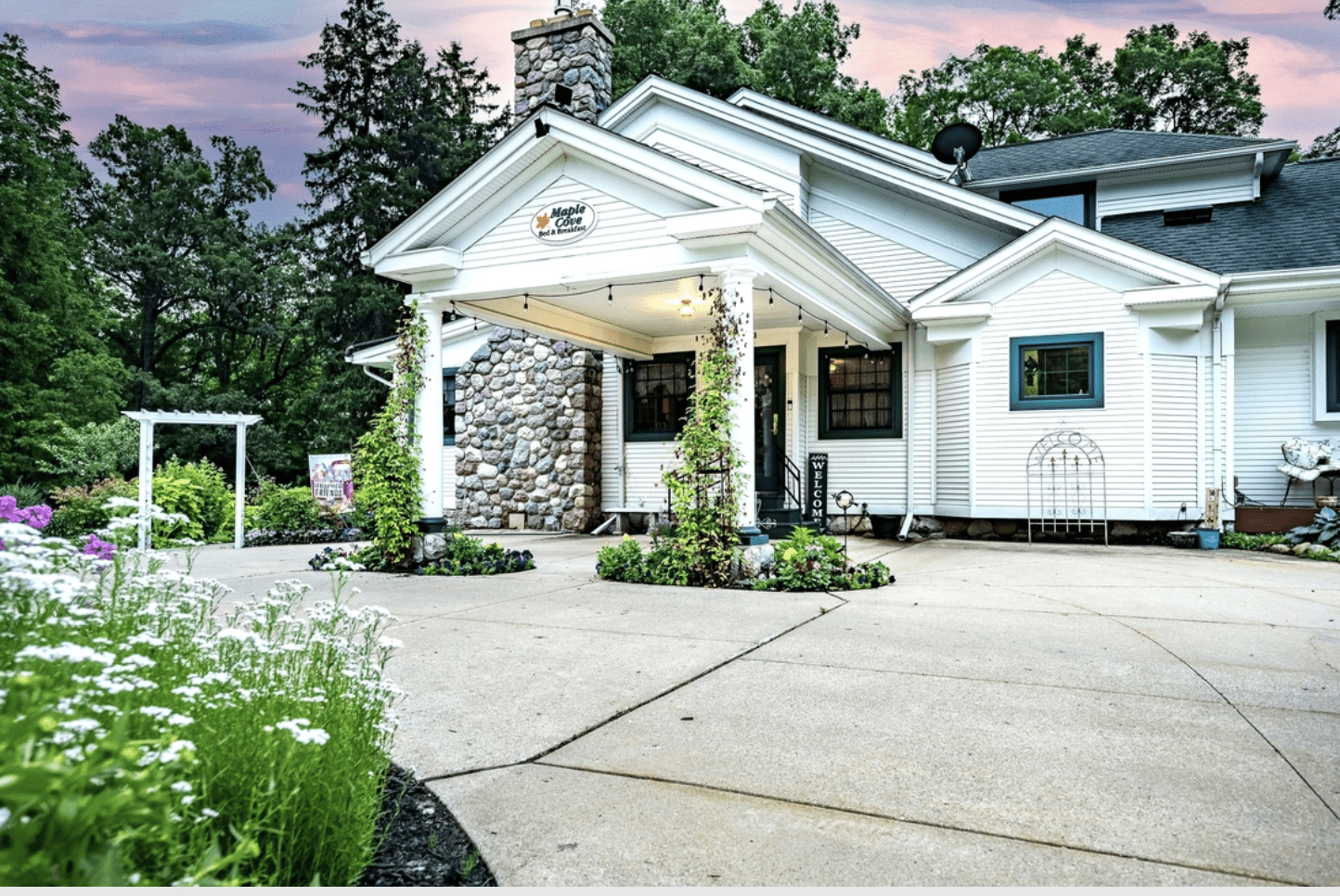 Entrance to the Maple Cove Bed and Breakfast a white overhang with sign