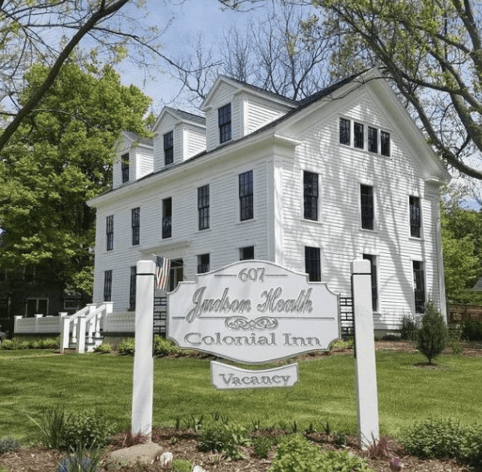 White colonial building with sign for the Judson Heath Colonial Inn