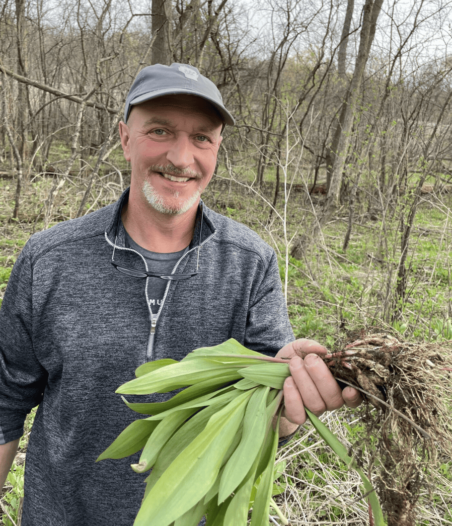 Chef Tim from Veritas Estate smiling while holding fresh produce