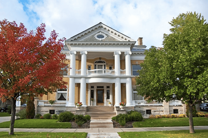 Exterior of the grand Cartier Mansion in Ludington. Yellow brick with grand white columns