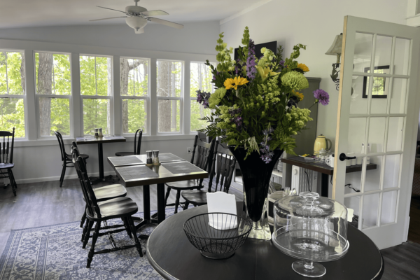 Round table with flowers and tables behind at the Vintage Inn at Veritas Estate