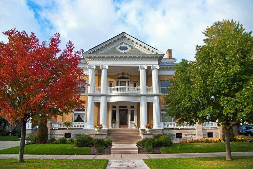 Cartier Mansion bed and Breakfast front of building in the fall