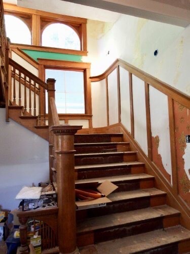 Stairway to the second floor has lovely woodwork.