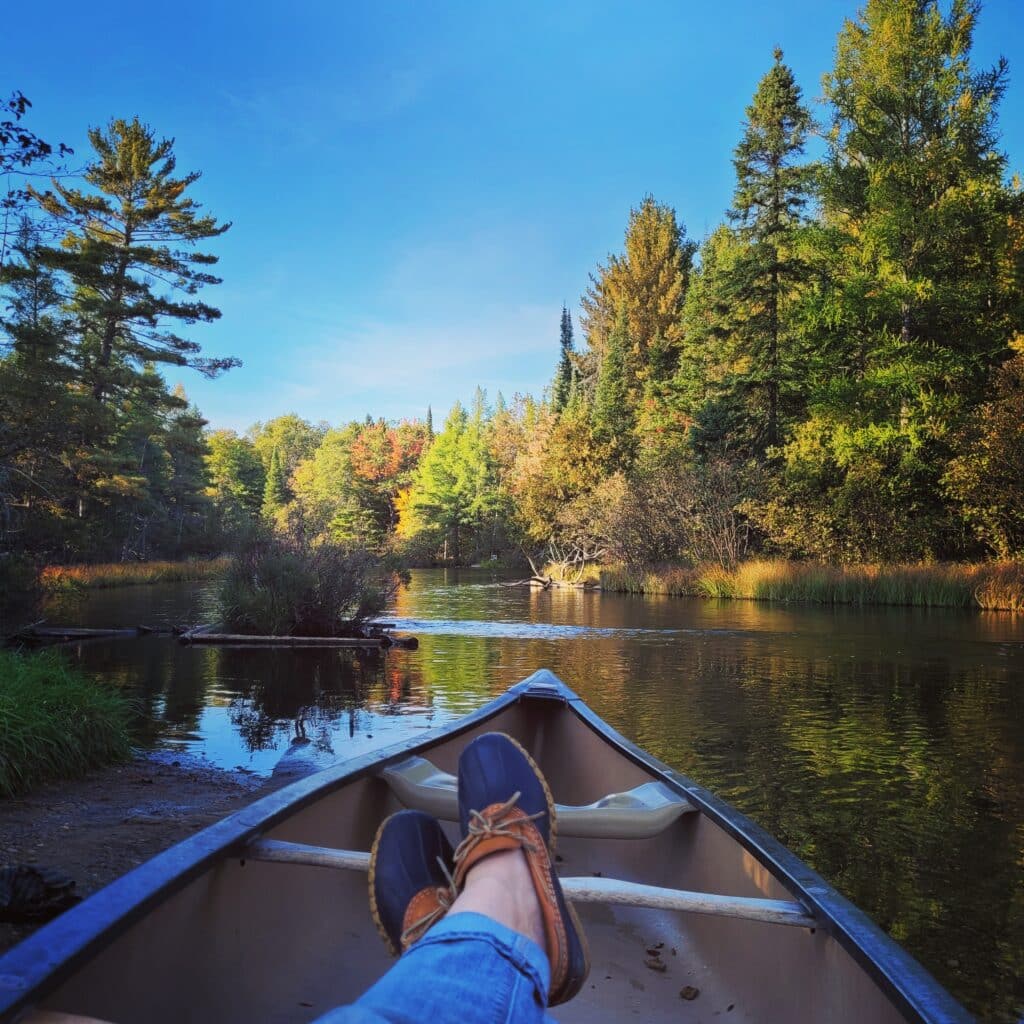 Woman in jeans canoeing on the AuSable