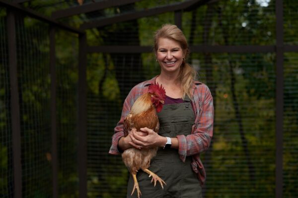 Woman holding a chicken