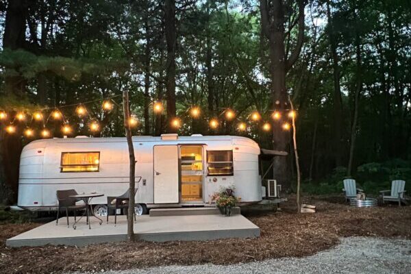 Vintage Camper with lights and a deck at Goldberry Woods