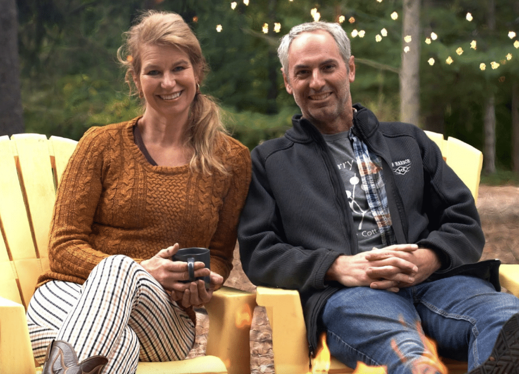 Couple sitting on yellow Adirondack chairs