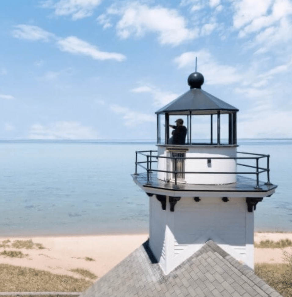 Man looking out from the top of a Michigan Lighthouse