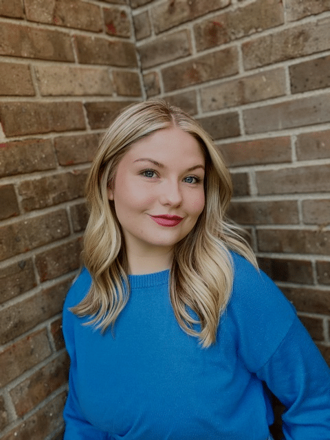 Blond girl with a blue sweater