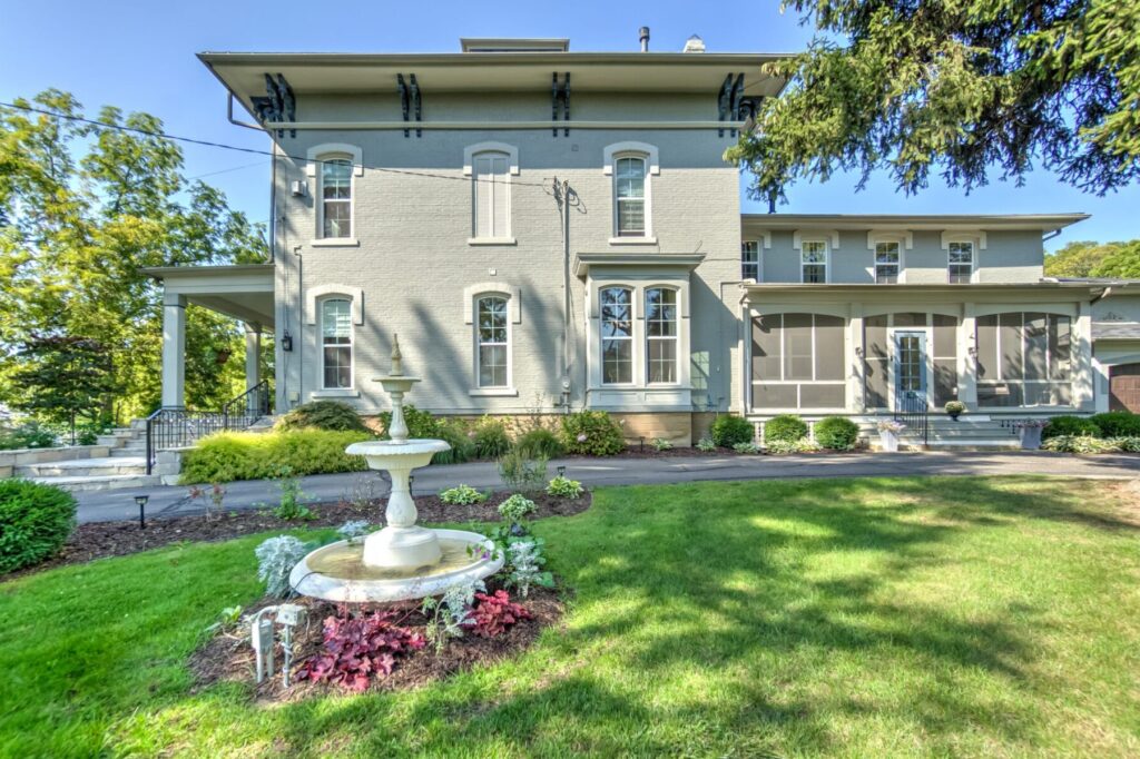 Villa on Verona Bed and Breakfast / Boutique Hotel, Front of building in summer with flowers and antique fountain