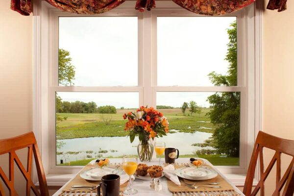 Breakfast at the Castle in the Country with views out the window of their lake