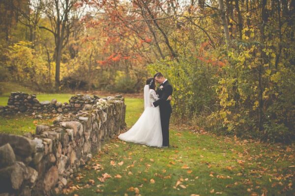 wedding couple beside a stone wall at the Castle in the Country