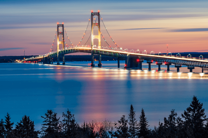 The Mackinac Bridge lighted at sunset