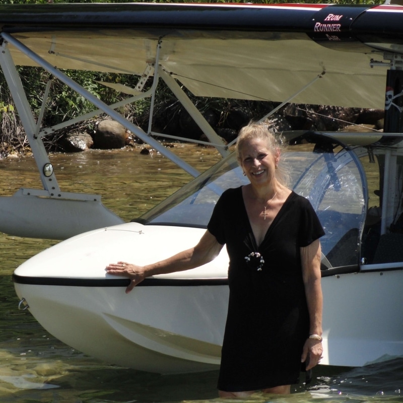 Torch Lake Bed and Breakfast Innkeeper, Deb Cannon in the lake with a sea plane