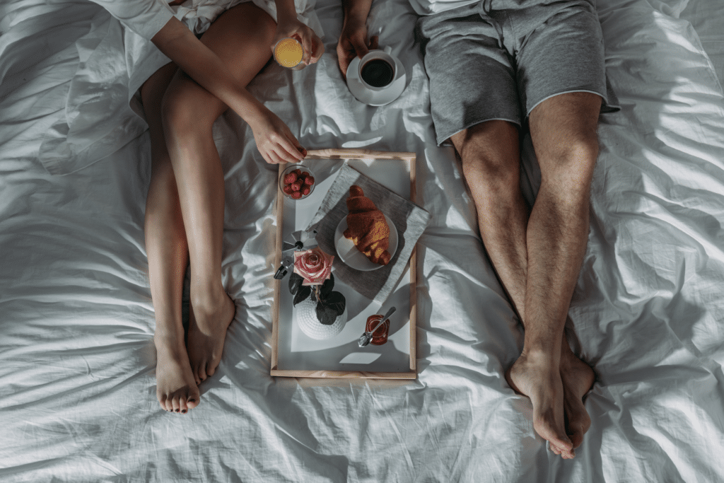 couple in bed with breakfast