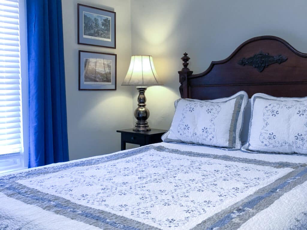 Bedroom with blue comforter at the Vines B&B