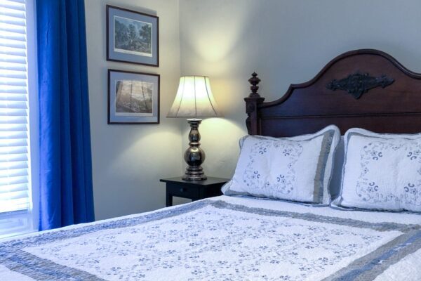 Bedroom with blue comforter at the Vines B&B